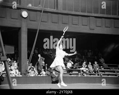 VICTOIRE AU TENNIS POUR BRITIAN MRS . Betty Hilton ( Grande-Bretagne ) saute pour retourner un coup élevé dans son match avec Mme . A.M. Seghers , de France , lors des championnats de tennis sur gazon au All - England Club , Wimbledon . Mme Hilton a gagné en deux sets , 7-5 , 6-2 . 21 juin 1949 Banque D'Images