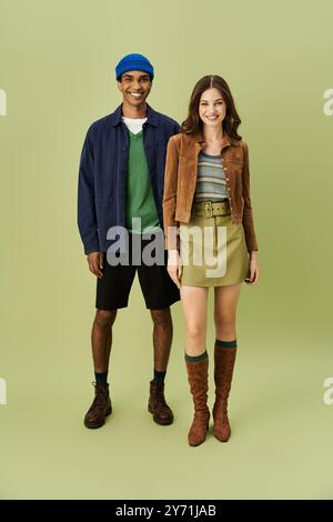 Un couple à la mode présente leur tenue d'automne tendance, rayonnant de chaleur et de style. Banque D'Images