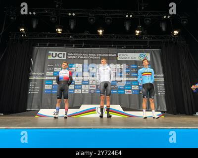 27 septembre 2024, Suisse, Zürich : cyclisme : Championnats du monde, course sur route U23, hommes : le nouveau champion du monde Niklas Behrens (M) d'Allemagne monte sur le podium aux côtés du slovaque Martin Svrcek (G) et du belge Alec Segaert pendant une minute de silence pour Muriel Furrer. Après le décès de la cycliste suisse Muriel Furrer aux Championnats du monde à Zurich, le jeune Allemand Niklas Behrens remporte le titre U23. Le jeune de 20 ans a remporté la première course après le tragique incident. Photo : Inga Jahn/dpa crédit : dpa Picture alliance/Alamy Live News Banque D'Images