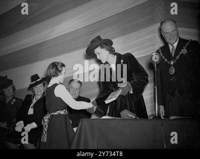 S.A.R. la duchesse de Kent a assisté aujourd'hui à la fête du président à l'école des victuallers agréés, Slough, Bucks, lorsqu'elle a remis les prix. Photos : la duchesse de Kent félicite la petite Valerie Barett, lauréate d'un prix junior. 27 mars 1946 Banque D'Images