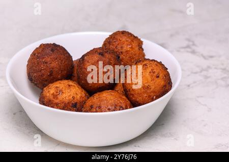 Bol avec de délicieuses boules de tofu frites sur fond blanc Banque D'Images