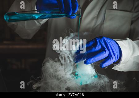 Une femme scientifique effectuant une réaction organique dans des conditions fumantes dans un laboratoire. Fumées, radioactives, fluorescence. Un arrière-plan noir d'espace de copie. Banque D'Images