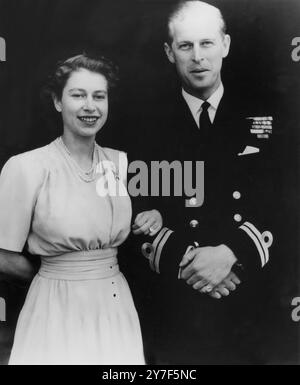 Paraissant radieusement heureuse, la princesse Elizabeth, portant sa bague de fiançailles, a été photographiée avec son fiancé, le lieutenant Philip Mountbatten au palais de Buckingham aujourd'hui. On a appris cet après-midi que lorsque la princesse se marie, elle conservera son nom de famille Windsor comme fille de la maison régnante de Windsor et que, par conséquent, tous les enfants du mariage, qui seraient dans la ligne directe de succession au trône, seraient princes ou princesses de la Maison Royale de Windsor. Photos : une charmante photo de la princesse Elizabeth et du lieutenant Philip Mountbatten au palais de Buckingham. Banque D'Images