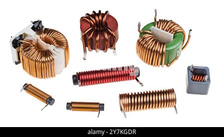 Ensemble de bobines toroïdales et cylindriques avec fil de cuivre isolé sur un fond blanc. Gros plan de diverses inductances ou transformateurs avec noyau de ferrite. Banque D'Images