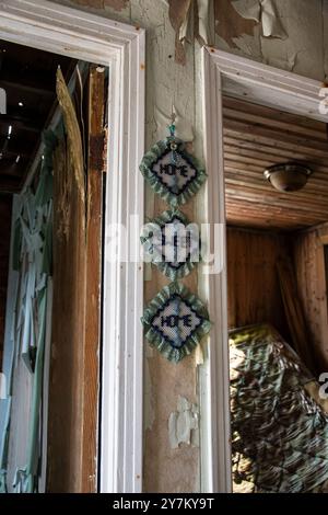 Maison Sweet home mur suspendu à l'intérieur d'une cabane abandonnée délabrée à Pouch Cove, Terre-Neuve-et-Labrador, Canada Banque D'Images