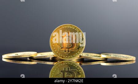 Bitcoin sur fond sombre, gros plan bitcoin doré une monnaie numérique, fonctionne sur un système décentralisé avec des transactions enregistrées et de nouvelles unités cr Banque D'Images