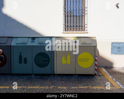 Mantoue, Italie 30 septembre 2024 quatre bacs de recyclage publics modernes debout sur une rue pavée avec une personne tenant une caméra en arrière-plan Banque D'Images