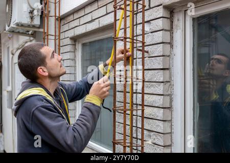 Construction worker. Worker in the construction site making reinforcement metal framework for concrete pouring Stock Photo