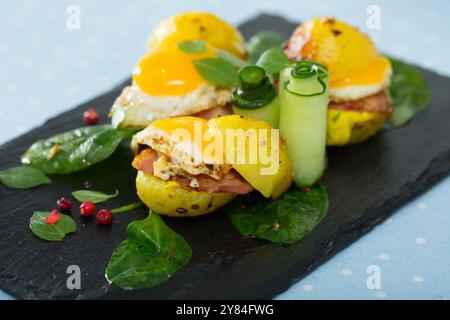 Gros plan des mini burgers des œufs de caille avec des pommes de terre cuites à l'assiette avec des légumes verts Banque D'Images