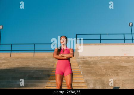 Athlète féminine confiante posant sur le stade pendant l'entraînement Banque D'Images