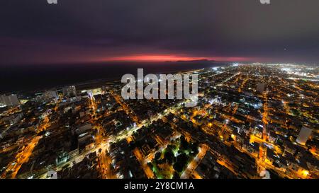 Vue aérienne ultra-large du paysage urbain dans le quartier de San Miguel avec le littoral la nuit Banque D'Images