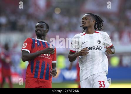 Match de football, Sinlord CONTEH 1. FC Heidenheim est parti et Jordy MAKENGO SC Freiburg arrivent trop tard, avec leurs yeux, ils suivent le ballon est sorti, pied Banque D'Images