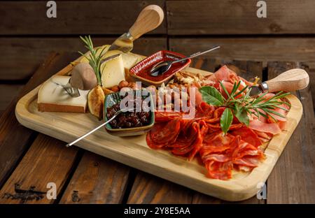 Un plateau de charcuterie gastronomique magnifiquement arrangé avec une variété de fromages et de noix Banque D'Images