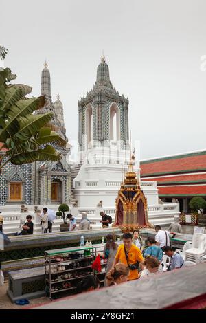 Visiteurs et pèlerins au Wat Phra Kaew avec stupa en arrière-plan, Bangkok, Thaïlande Banque D'Images