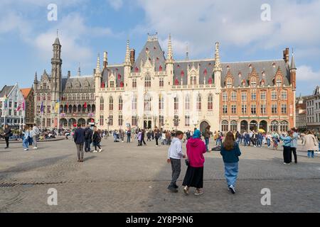 Touristes sur la populaire place du marché, Grote Markt, à Bruges en Belgique avec le Palais provincial, Provinciaal Hof Banque D'Images