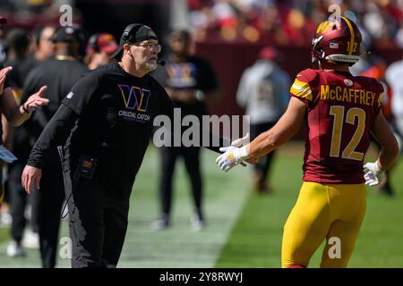 Landover, MD, États-Unis. 6 octobre 2024. Dan Quinn, entraîneur-chef des Washington Commanders, serre la main au receveur Luke McCaffrey (12 ans) pendant le match de la NFL entre les Browns de Cleveland et les Commanders de Washington à Landover, MD. Reggie Hildred/CSM/Alamy Live News Banque D'Images