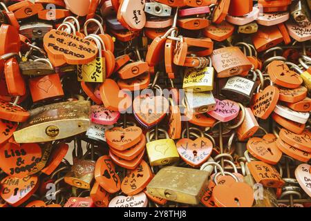 Vérone, Italie, juin 2022 : fond de serrures en forme de cœur sur un mur, symbole de l'amour pour toujours, Europe Banque D'Images