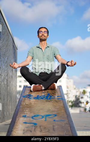 Homme arabe zen pactiquant le yoga sur le skate Park nevada à Casablanca au Maroc Banque D'Images