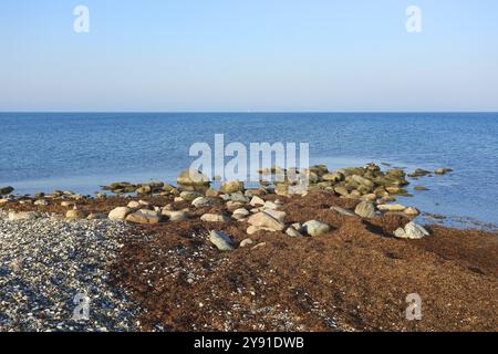 Plage de pierres sur l'île de Fehmarn par une journée calme et ensoleillée, côte de la mer Baltique près de Wallnau, East Holstein, Schleswig-Holstein, Allemagne, Europe Banque D'Images