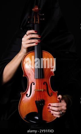 Femme drapée de tenir son violon noir Banque D'Images