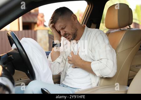 Homme blessé près d'un airbag ouvert dans une automobile après un accident de voiture Banque D'Images