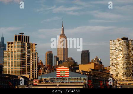 Une vue imprenable sur les gratte-ciel de New York au coucher du soleil, mettant en valeur un mélange d'architecture moderne et historique. Le stand emblématique de l'Empire State Building Banque D'Images