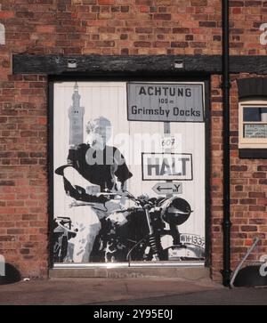 Grimsby Docks Grimsby, Lincolnshire, Angleterre Royaume-Uni 8 octobre 2024 Une fresque murale de Steve McQueen (nom complet Terrence Stephen McQueen) basée sur son rôle dans le film, « la Grande évasion ». Il y a une image de Grimsby Dock Tower dans le fond, il a été surnommé le «Roi du cool». Il a utilisé le pseudonyme Harvey Mushman dans les courses automobiles. ©GED Noonan/Alamy Banque D'Images