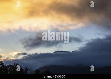 Nuages à l'aube et flocons de brume sur une chaîne de montagnes, Berg Mugel, Leoben, Styrie, Autriche, Europe Banque D'Images