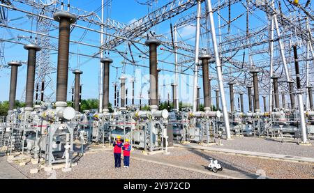 CHUZHOU, CHINE - 8 OCTOBRE 2024 - un robot intelligent et le personnel d'exploitation et de maintenance effectuent une inspection spéciale de l'équipement principal i. Banque D'Images