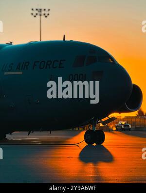 Le soleil se lève derrière un C-17 Globemaster III affecté à la 911e escadre de transport aérien, à la station de réserve aérienne de l'aéroport international de Pittsburgh, le 8 octobre 2024. Pittsburgh IAP ARS soutient les missions de transport aérien depuis la IIe Guerre mondiale bien qu'il ait évolué au fil des ans, sa mission de fournir une mobilité aérienne rapide reste un élément essentiel de la défense nationale. (Photo de l'US Air Force par le Sgt. Maître Jeffrey Grossi) Banque D'Images