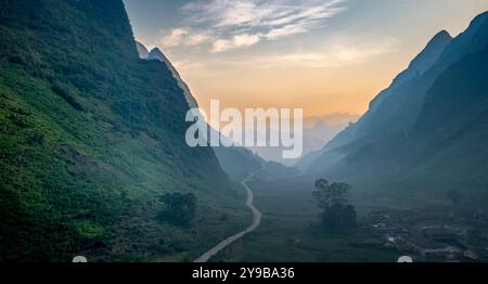 Une vaste vallée à Dong Van, province de Ha Giang, Vietnam entourée de majestueuses montagnes calcaires. Les falaises abruptes et imposantes créent un sauvage et majestueux Banque D'Images