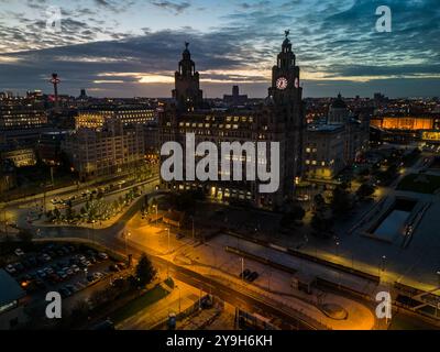 Cette vue aérienne captivante capture la beauté architecturale de l'emblématique bâtiment du foie de liverpool alors que la ville passe du jour à la nuit Banque D'Images