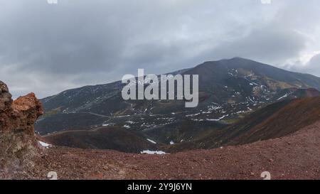 Roches volcaniques rouges colorées au paysage de montagne de l'Etna près des cratères Silvester par une journée nuageuse d'hiver, Catane, Sicile, Italie Banque D'Images