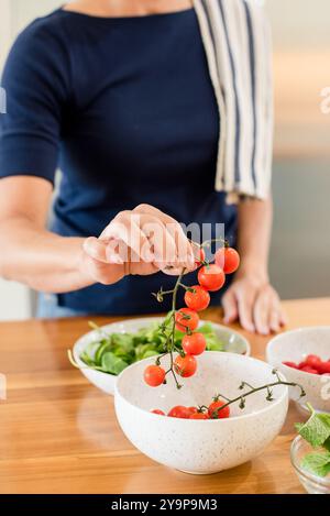 Gros plan des mains de femmes tenant des tomates cerises Banque D'Images