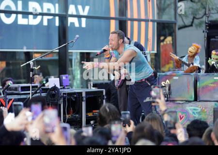 New York. 08 octobre 2024. NEW YORK, NEW YORK - 08 OCTOBRE : Chris Martin de Coldplay se produit en direct dans le spectacle 'Today' de NBC au Rockefeller Plaza le 8 octobre 2024, à New York. Le groupe de rock britannique a livré une performance énergique, captivant le public avec leurs chansons à succès. Les fans se sont rassemblés tôt le matin pour assister à l'événement, bravant le temps de l'automne pour avoir la chance de voir Coldplay en direct en action. (Crédit : Giada Papini/EuropaNewswire)/dpa/Alamy Live News Banque D'Images