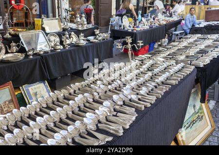 Un marché aux puces avec de nombreux stands exposant des couverts en argent antique et d'autres articles, Paris Banque D'Images