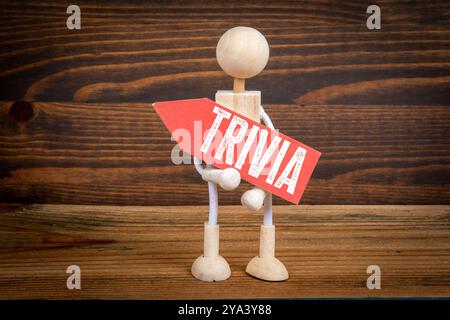 ANECDOTE. Flèche pointant en rouge avec texte. Figurines humaines miniatures. Banque D'Images