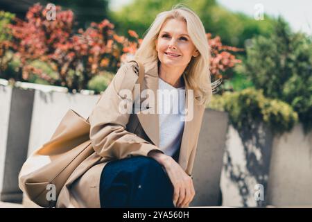 Photo de belle jolie femme rêveuse habillée vêtements à la mode marchant et profitant de la journée ensoleillée de la météo d'automne Banque D'Images