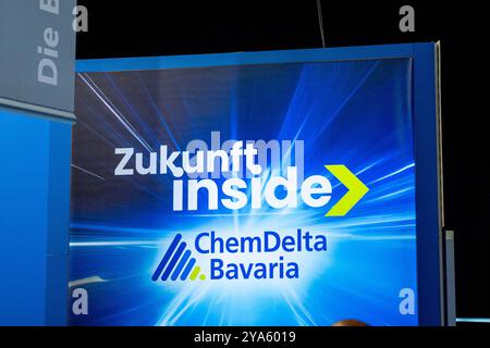 Augsburg, Bavière, Allemagne - 12 octobre 2024 : stand ChemDelta Bavaria à la conférence CSU, présenté sous la devise : future Inside. Le stand est conçu avec des graphiques bleus et jaunes symbolisant les technologies modernes et l'industrie chimique *** Messestand von ChemDelta Bavaria auf dem CSU-Parteitag, präsentiert unter dem devise : Zukunft Inside. Der stand ist mit blauen und gelben Grafiken gestaltet, die moderne Technologien und die chemische industrie symbolisieren Banque D'Images