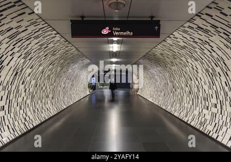 Lisbonne, Portugal, 12 28 2018 : une jeune femme s'éloignant au milieu du tunnel piétonnier souterrain de la station de métro Saldanha, en Europe Banque D'Images