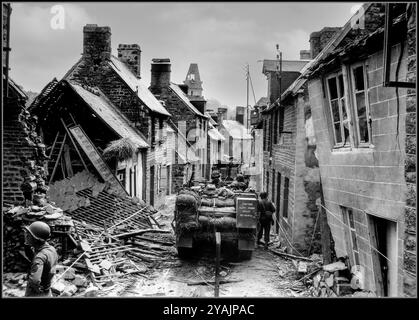 WW2 NORMANDIE les demi-pistes américaines M2 traversent lentement la rue Saint Michel en ruine à Lonlay L'Abbaye, le 14 août 44. Après des batailles féroces avec les forces d'occupation de l'Allemagne nazie après l'assaut initial sur le jour J Normandie France les demi-pistes du combat Command A de la 2ème division blindée américaine se déplacent lentement vers le bas de la rue Saint Michel devant un certain nombre de bâtiments en ruine. Normandie France Banque D'Images
