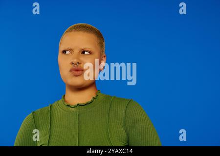 Une jeune femme met en valeur son sens audacieux de la mode avec un look et une expression distinctifs. Banque D'Images