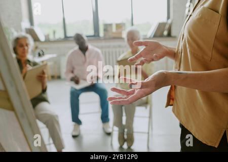 Gros plan moyen de mains féminines méconnaissables gesticulant dans l'air pendant l'explication Banque D'Images