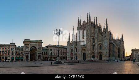 Une photo de la Piazza del Duomo au lever du soleil, avec le Duomo di Milano ou la Cathédrale de Milan sur la droite, et la Galleria Vittorio Emanuele II sur le L. Banque D'Images