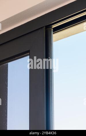 Ce détail saisissant capture la ligne élégante d'une porte coulissante, soulignant son design contemporain contre un ciel bleu calme, créant une ouverture et une ai Banque D'Images