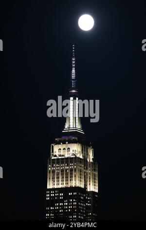 New York, New York, États-Unis. 16 octobre 2024. Une pleine lune se lève sur l'Empire State Building le 16 octobre 2024 à New York. La Super Hunter's Moon de ce soir, la pleine lune la plus grande et la plus brillante de l'année est la pleine lune la plus proche de l'année. (Crédit image : © Bryan Smith/ZUMA Press Wire) USAGE ÉDITORIAL SEULEMENT! Non destiné à UN USAGE commercial ! Banque D'Images