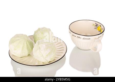 Sucrée délicieuse guimauve de poire sur soucoupe en céramique avec tasse, macro isolé sur fond blanc. Banque D'Images