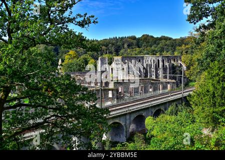 Belle abbaye de Villers du 12ème siècle entourée de feuilles d'automne par une journée ensoleillée vue de derrière un viaduc de chemin de fer. Villers-la-ville, Belgique. Banque D'Images