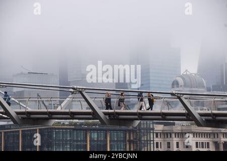 Londres, Royaume-Uni. 18 octobre 2024. Les gens marchent le long du Millennium Bridge tandis que le brouillard descend sur la City de Londres, le quartier financier de la capitale. Crédit : Vuk Valcic/Alamy Live News Banque D'Images