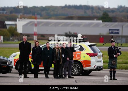 Les membres de la famille et le dirigeant par intérim de l'ALBA, Kenny MacAskill (à gauche), saluent le cercueil de l'ancien premier ministre d'Écosse Alex Salmond à l'aéroport d'Aberdeen, alors qu'il est rapatrié au Royaume-Uni après son décès samedi après-midi à l'Institute for Cultural Diplomacy Forum dans la ville balnéaire d'Ohrid en Macédoine du Nord. Date de la photo : vendredi 18 octobre 2024. Banque D'Images